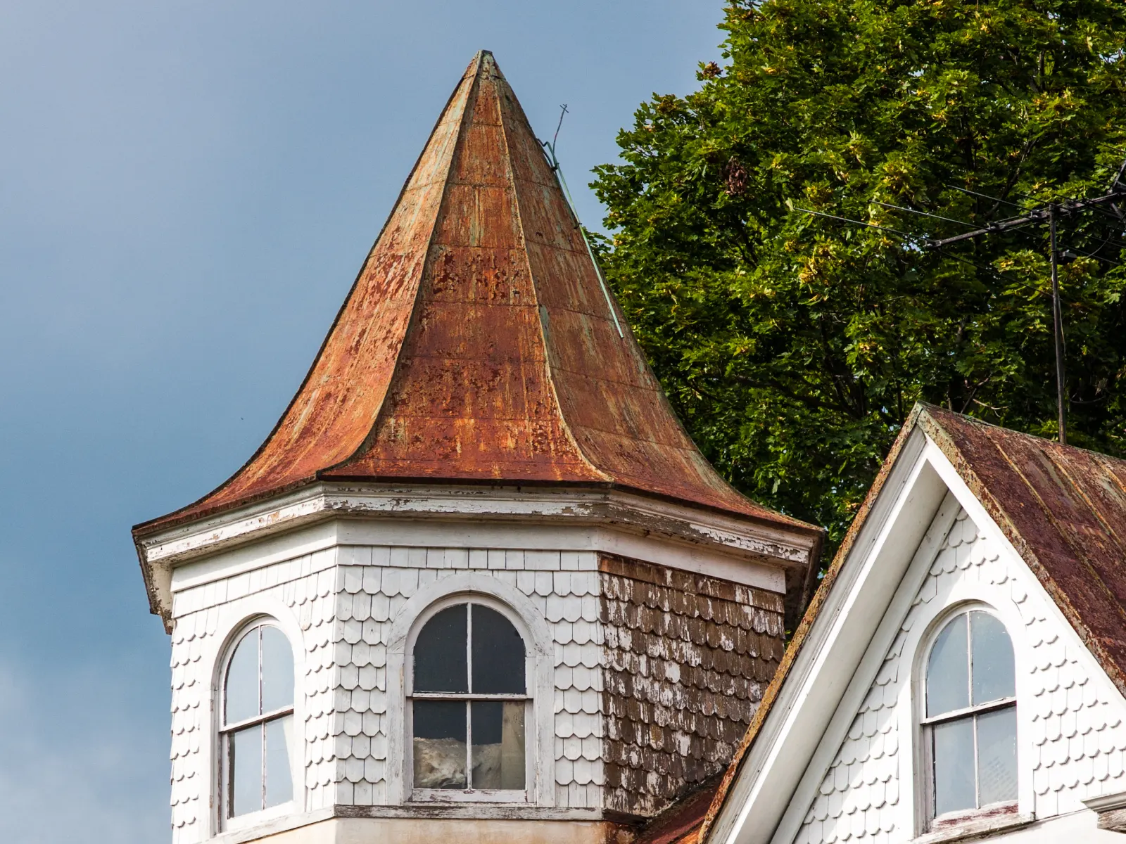 A Victorian house with a rusted conical turret in Bluemont