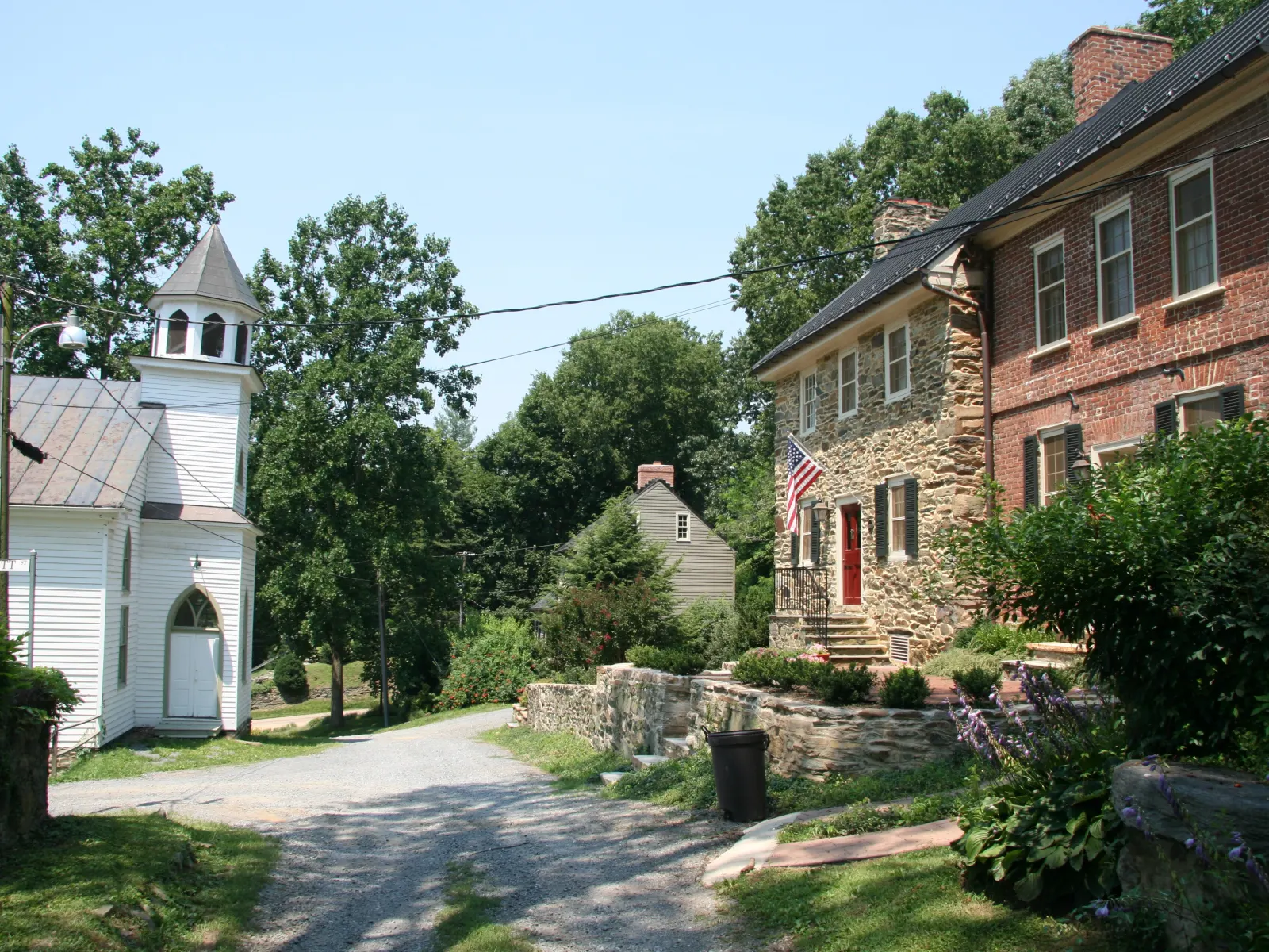 Stone and brick houses and a white church on Liggett Street in Waterford